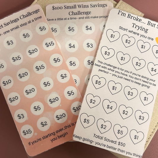 Three cards with money-themed designs on a brown surface