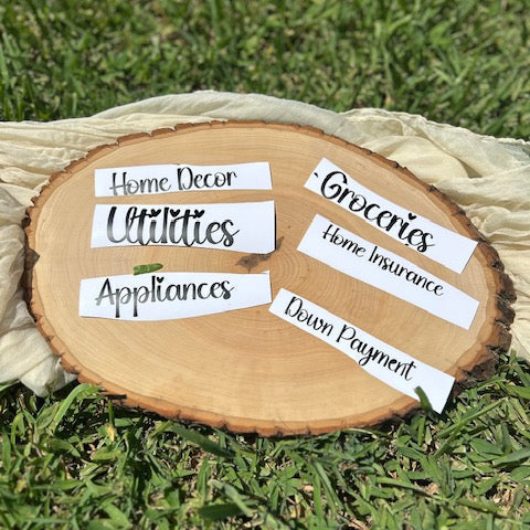 Wooden slice with labeled expenses on a grassy background