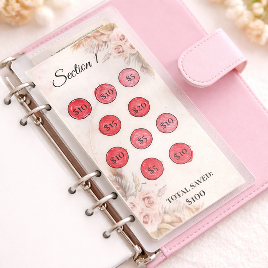 Pink planner with money-saving stickers and a floral design on a white background