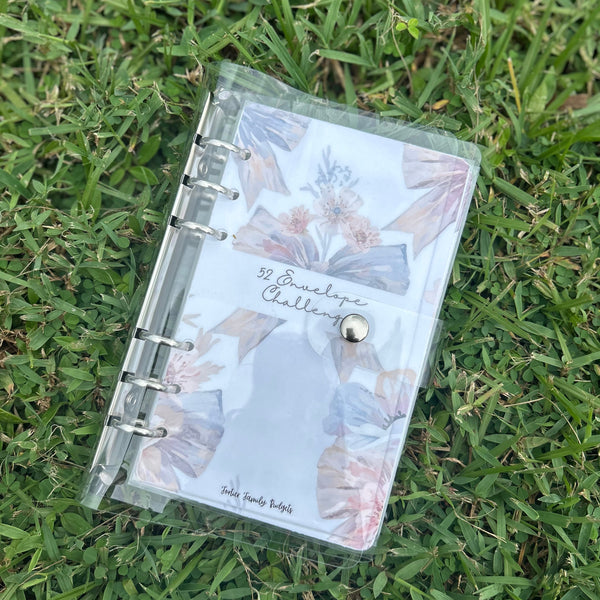 Clear planner with floral designs on grass