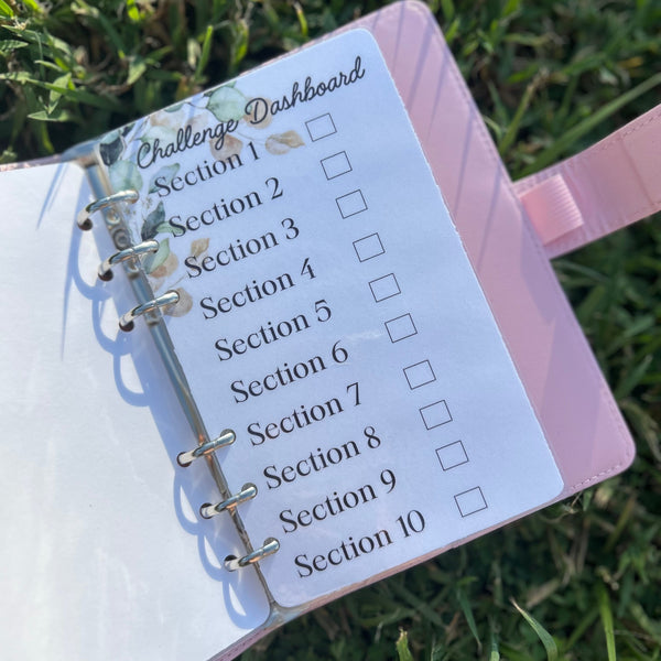 Planner with 'Challenge Dashboard' on grass
