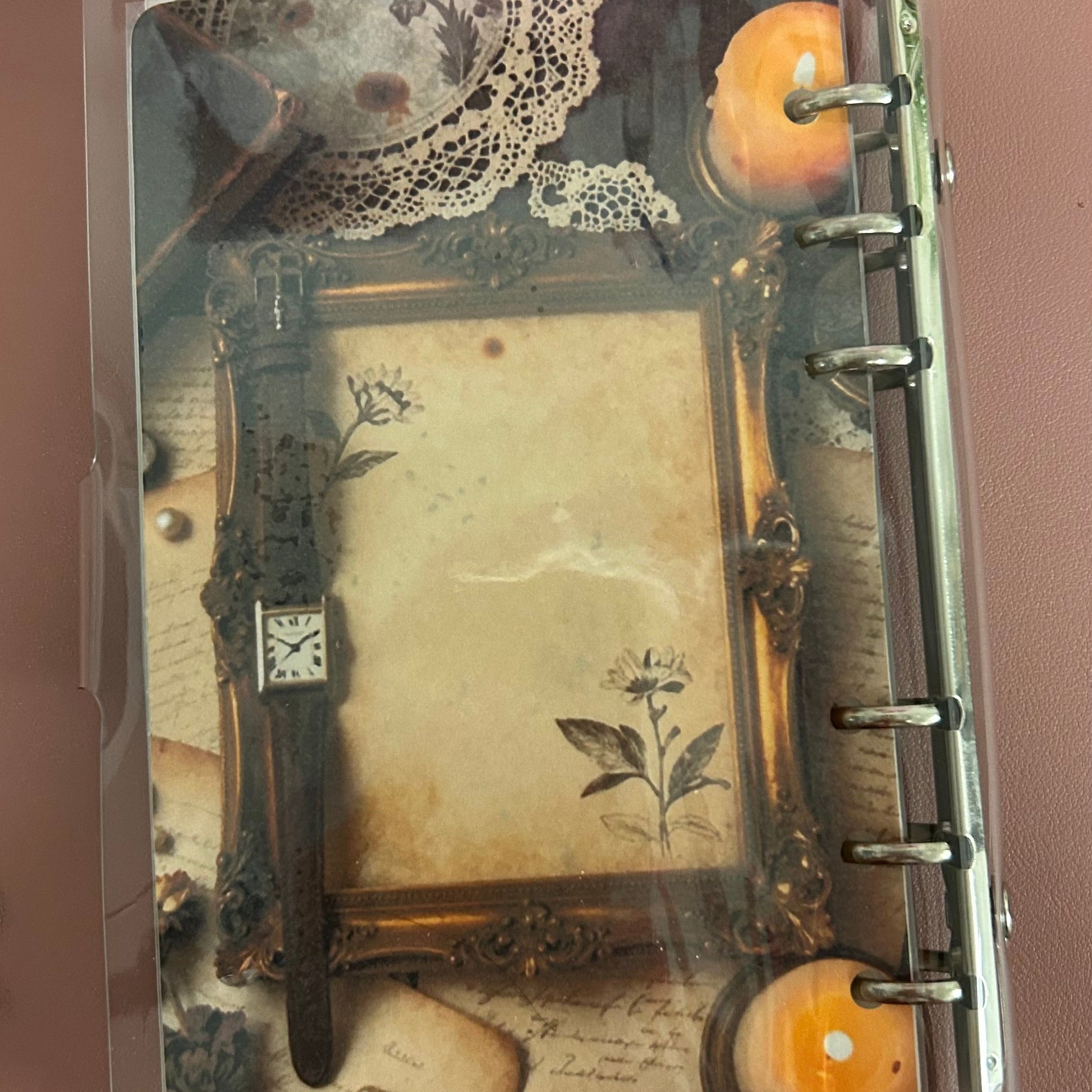 Decorative notebook with lace and vintage design elements on a brown background