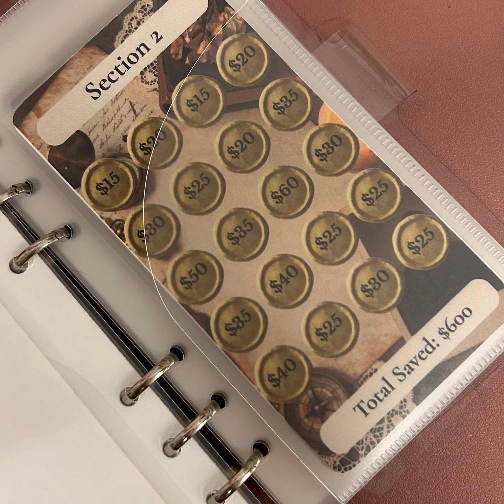 Personalized money tracker with gold coins and labels on a white background