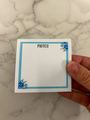 Blue floral sticky notes with elegant flower patterns, ideal for jotting down reminders, to-do lists, or adding a touch of charm to your workspace or planner.