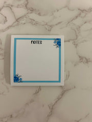 Blue floral sticky notes with elegant flower patterns, ideal for jotting down reminders, to-do lists, or adding a touch of charm to your workspace or planner.