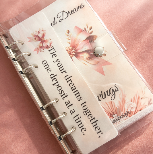 Planner with floral design and motivational quote on a pink background