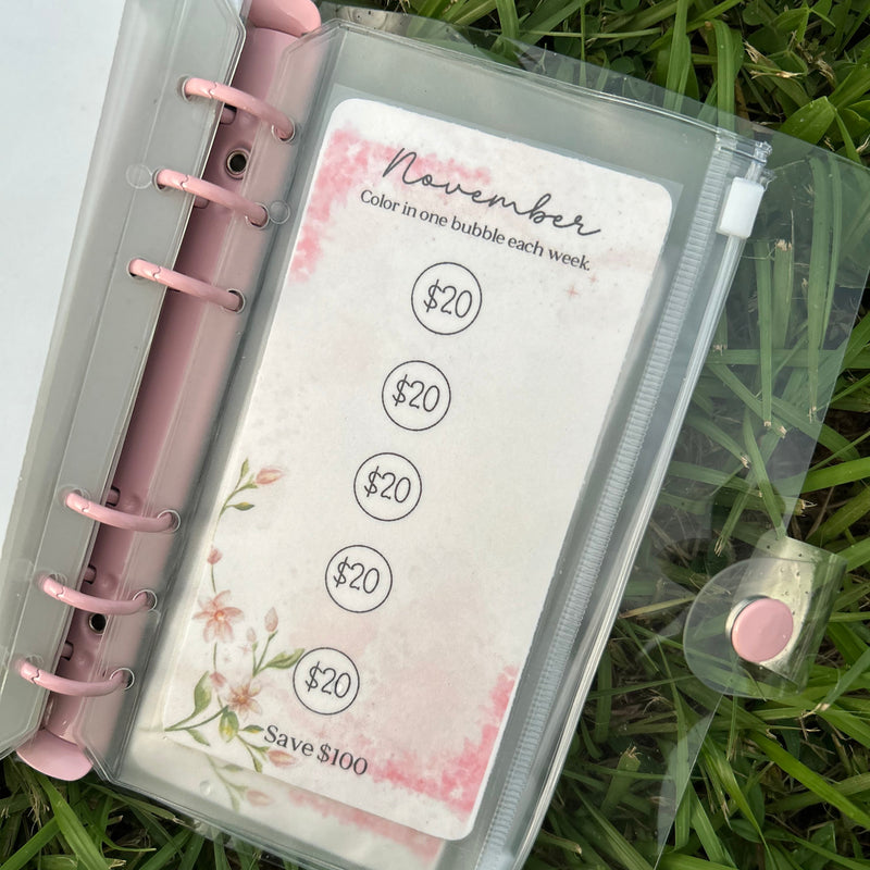 Planner with pink rings on a grass background
