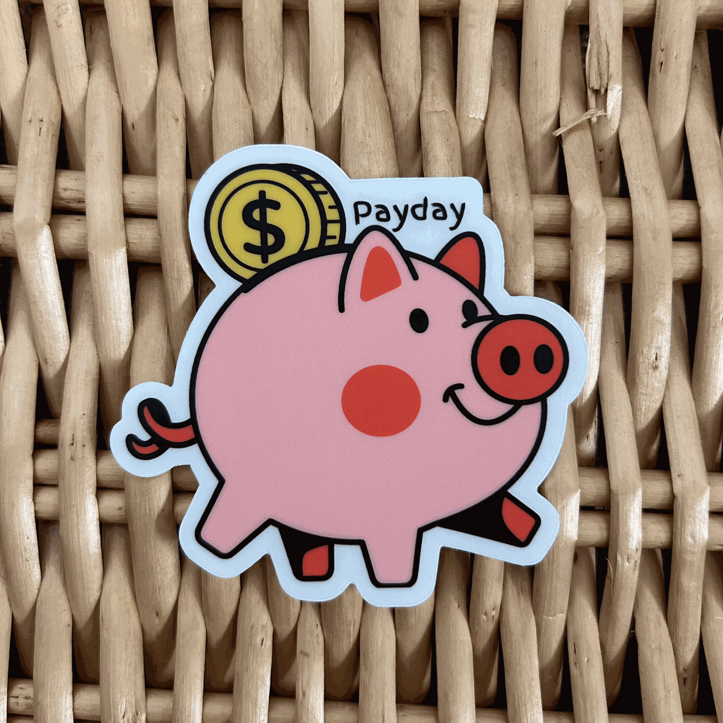 A custom sticker depicting a pink piggy bank with the words 'Payday' on a woven background.