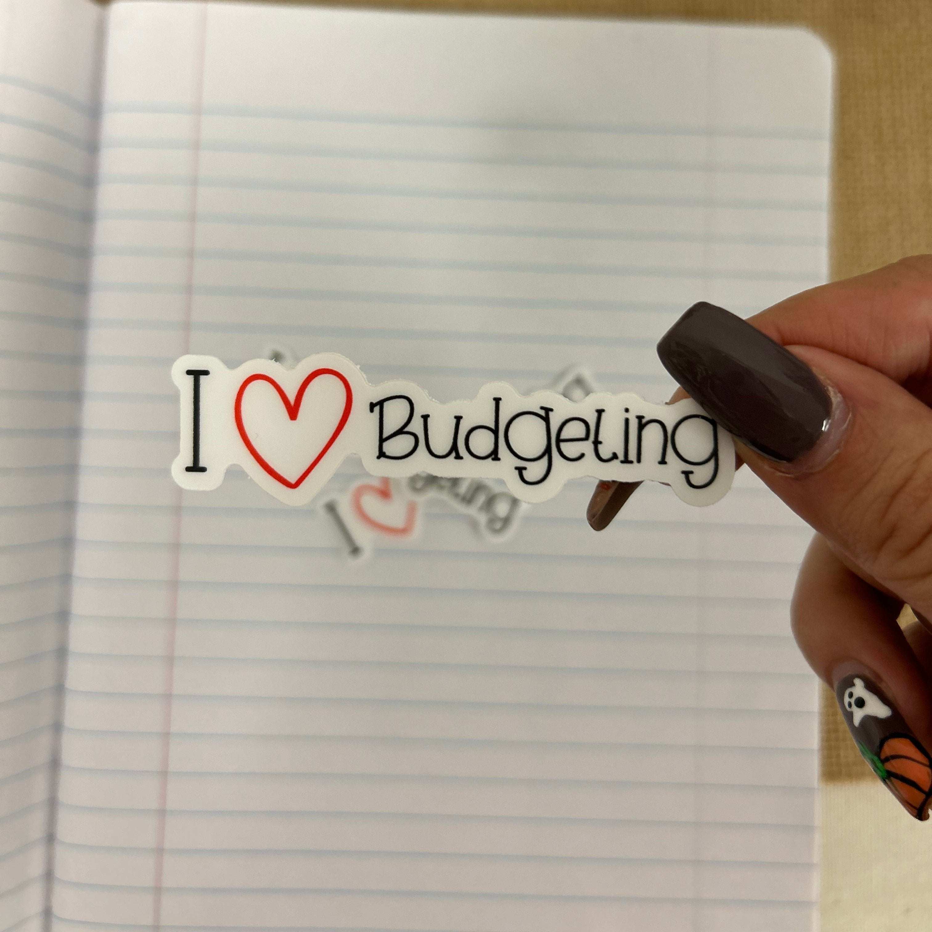 This Custom sticker that is colorful 'I Love Budgeting' sticker featuring bold, playful lettering with a heart icon, perfect for planners, laptops, or journals to show off a love for financial planning and money management.