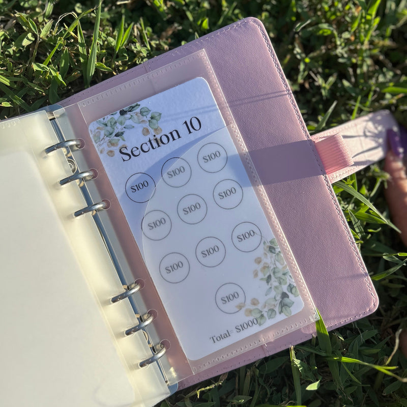 Pink planner with a section label on grass