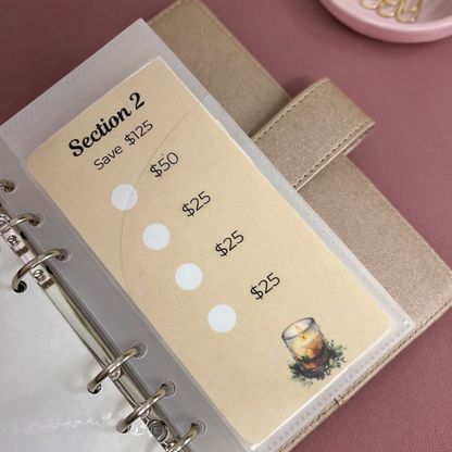 Beige money tracker with sections for saving money on a pink surface