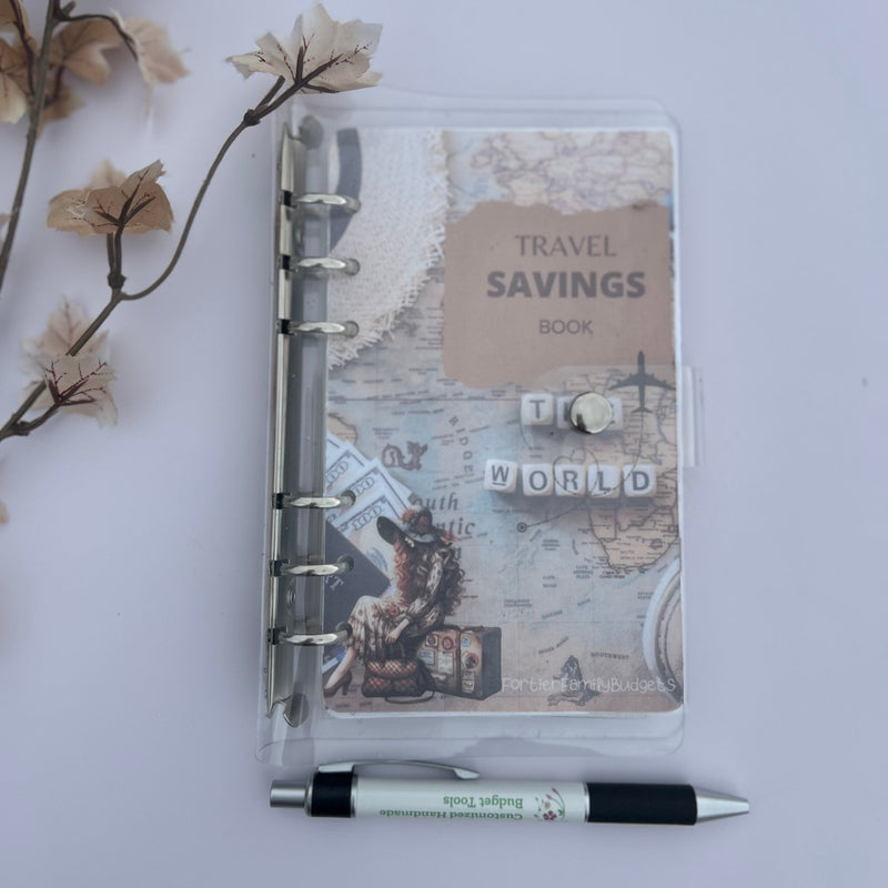 Travel savings notebook with a pen on a light gray background