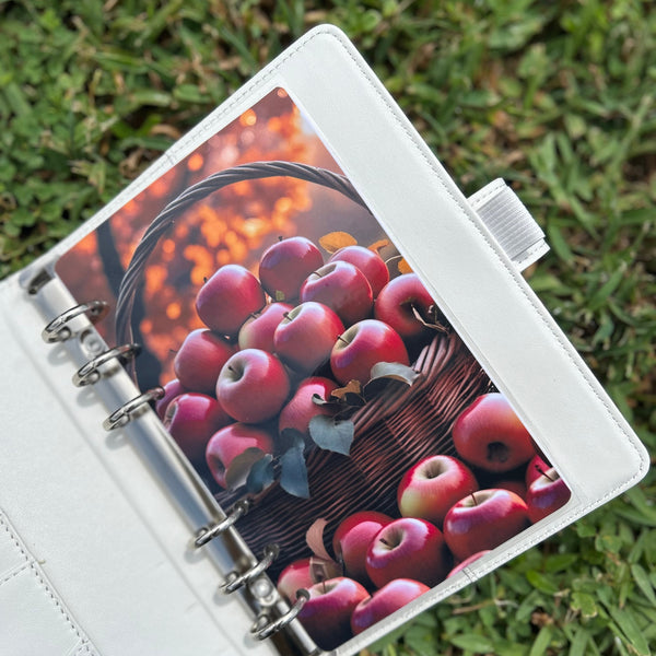 Planner with an apple design on a grass background