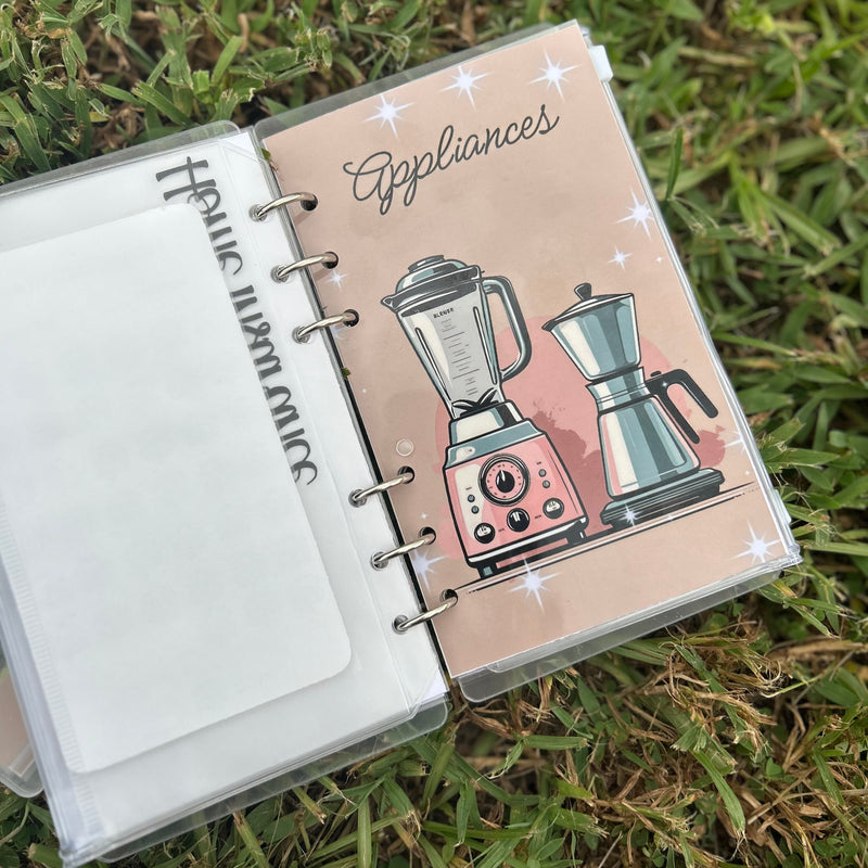 Notebook with appliance illustrations on a grass background