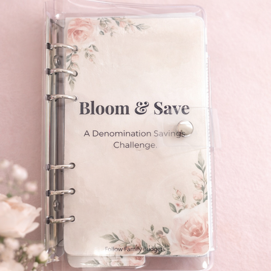 Floral-themed savings challenge notebook on a pink background with flowers.