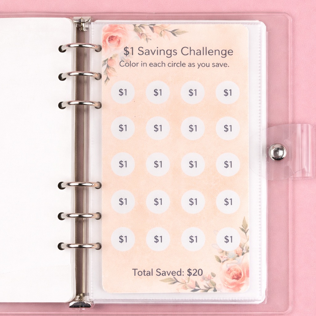Savings challenge tracker in a pink planner on a pink background
