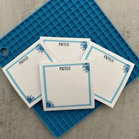 Blue floral sticky notes with elegant flower patterns, ideal for jotting down reminders, to-do lists, or adding a touch of charm to your workspace or planner.