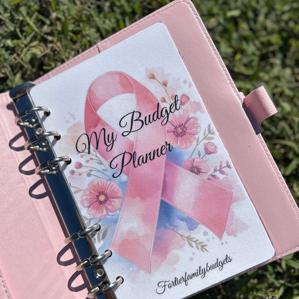 Pink budget planner with a ribbon design on a grass background