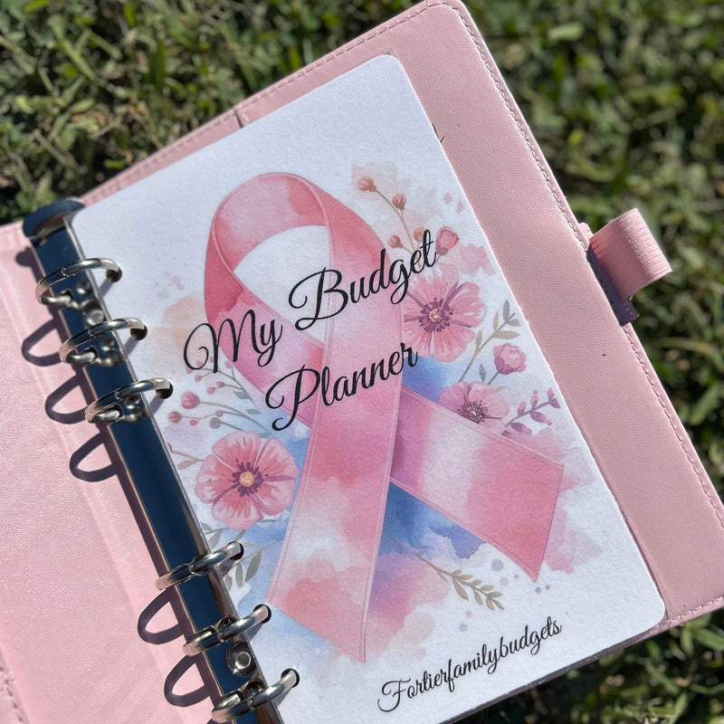 Pink budget planner with a ribbon design on a grass background