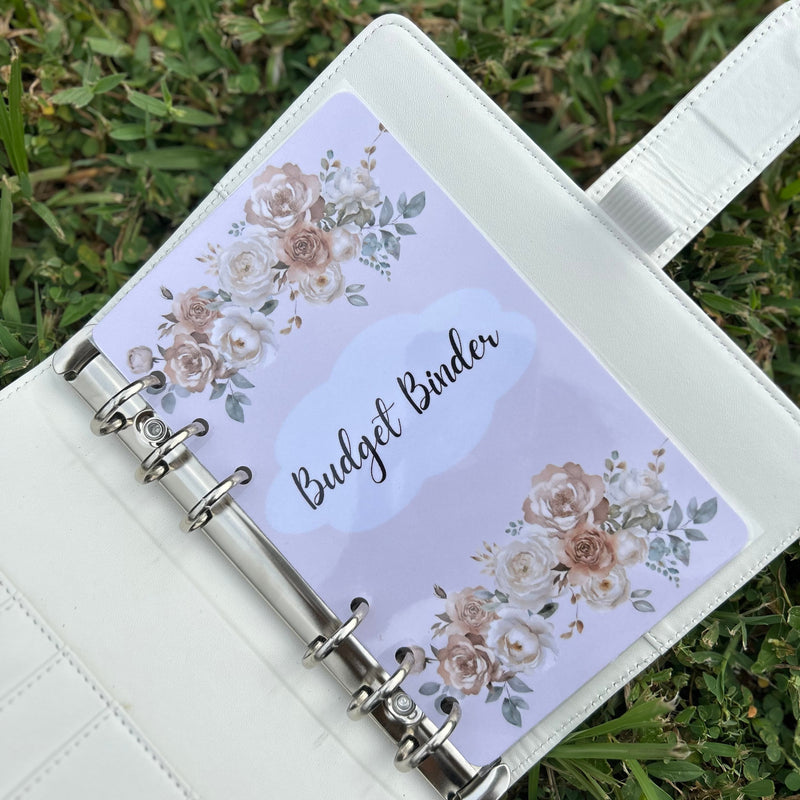 Budget binder with floral design on a grass background