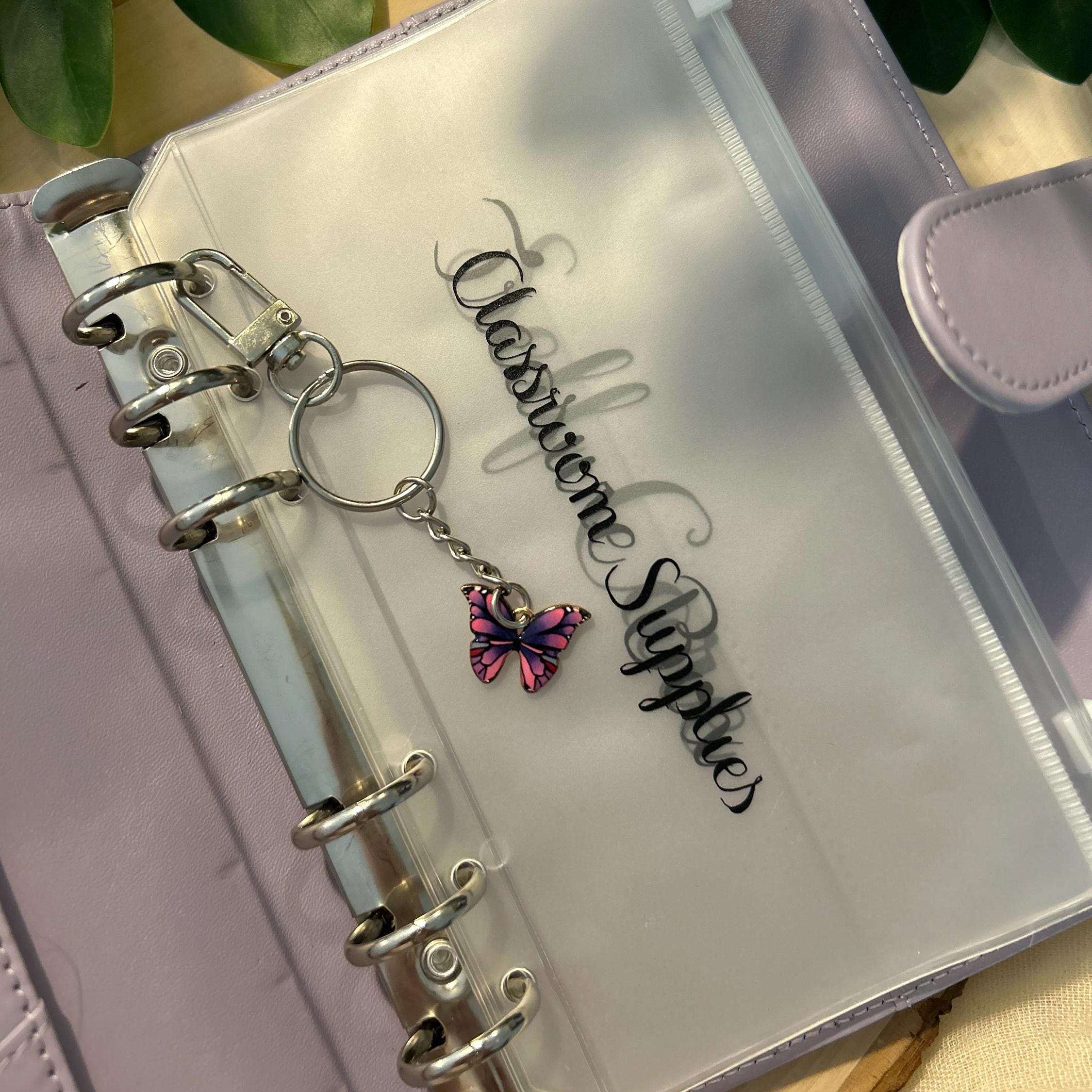 Elegant butterfly keychain and binder charm featuring a delicate butterfly design, perfect for accessorizing planners, budget binders, or keyrings with a touch of nature-inspired beauty.