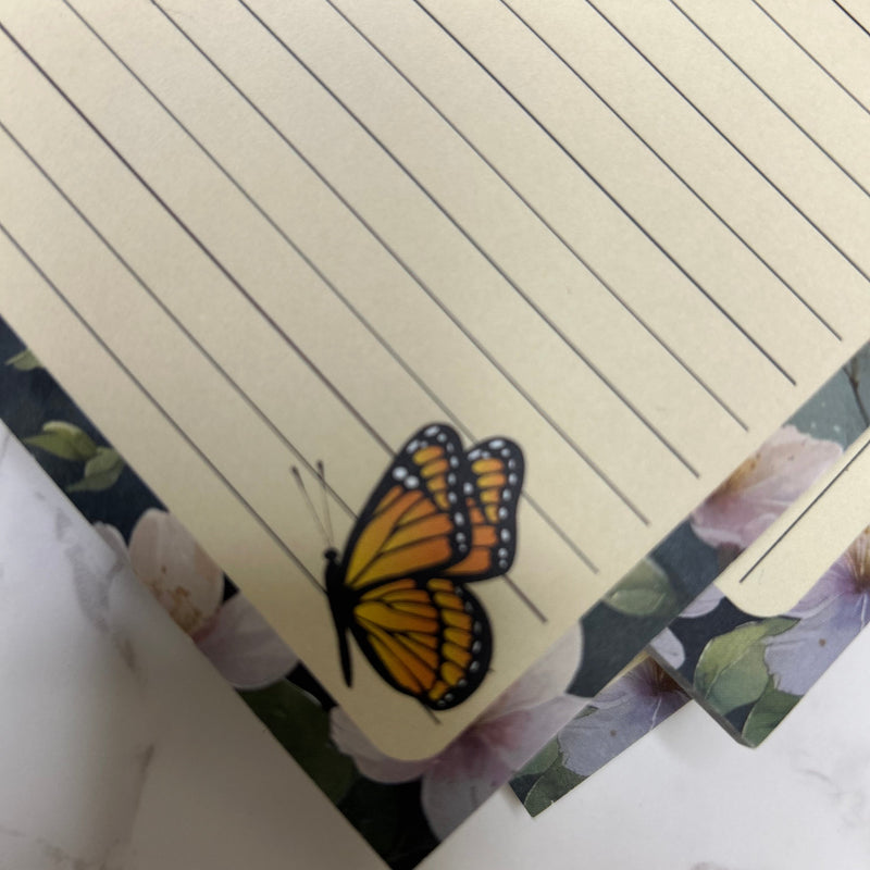 Notebook with a butterfly design on a floral background