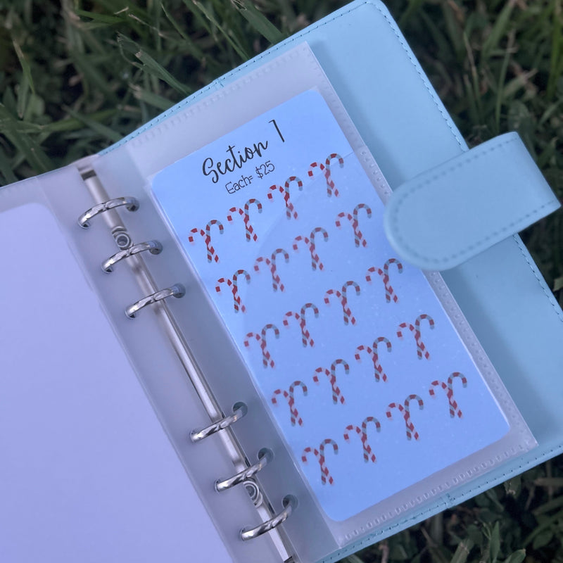 Planner with a sheet of stickers featuring question marks on grass background