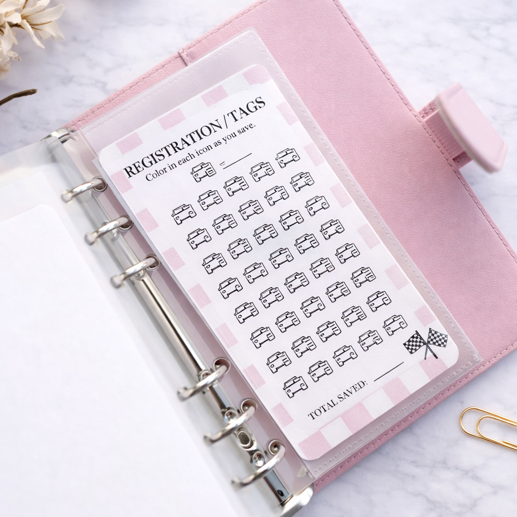 Pink planner with a sheet of registration tags on a light background