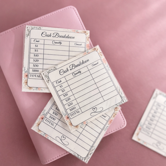 Cash breakdown sheets on a pink surface