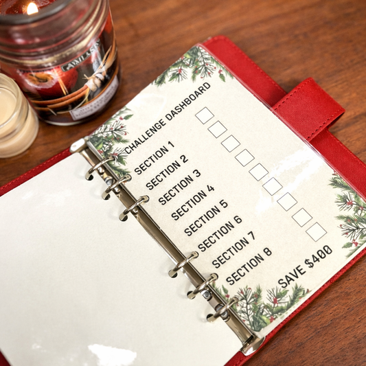 Planner with Christmas design on a wooden surface next to a candle