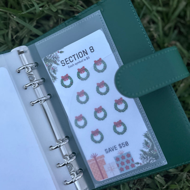 Green planner with a section cover featuring Christmas designs on grass