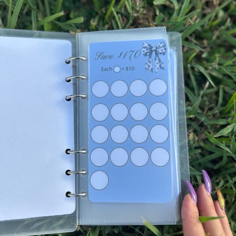 Planner with a blue sticker sheet on grass