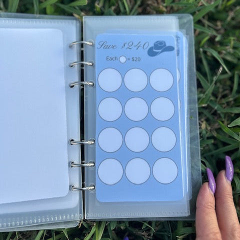 Planner with a sheet of round stickers on grass