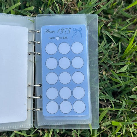 Small notebook with a clear plastic cover on grass