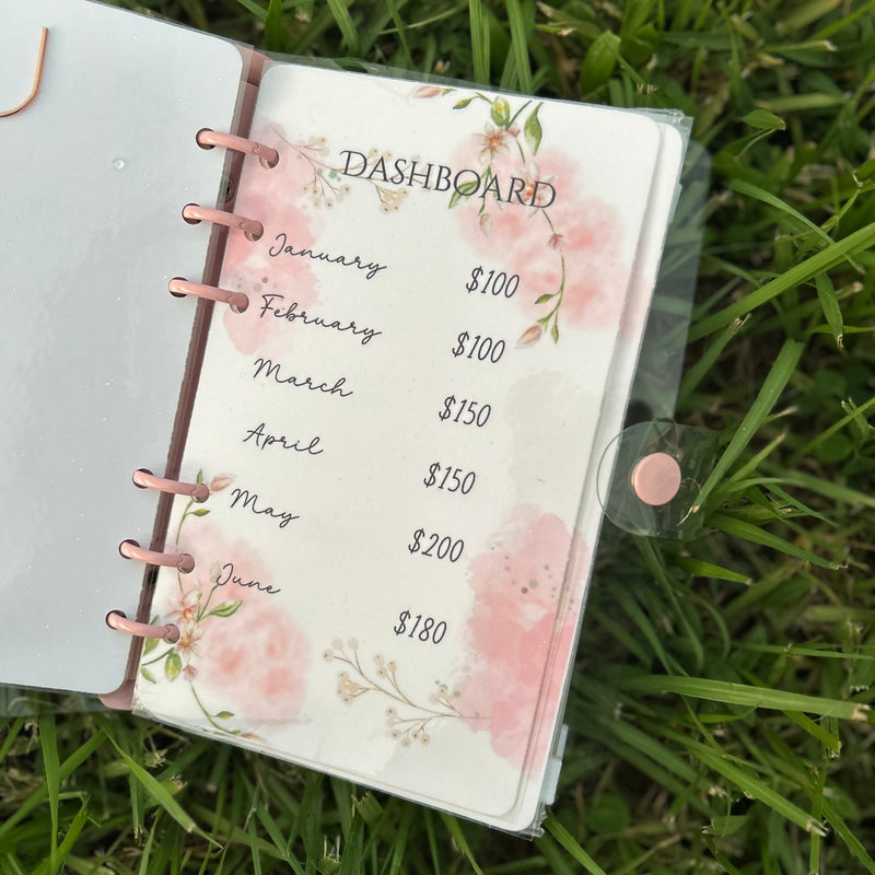Planner with floral design on a grass background