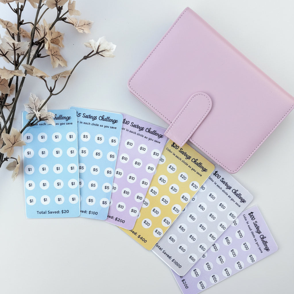 Set of savings challenge stickers with a pink organizer on a light blue background.