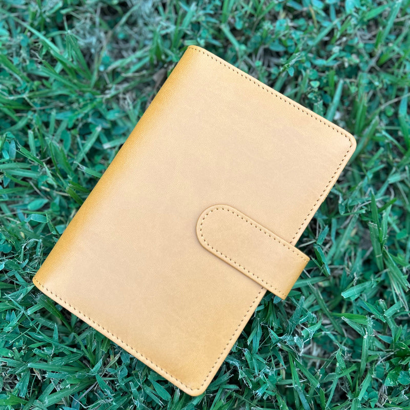 Yellow leather wallet on grass