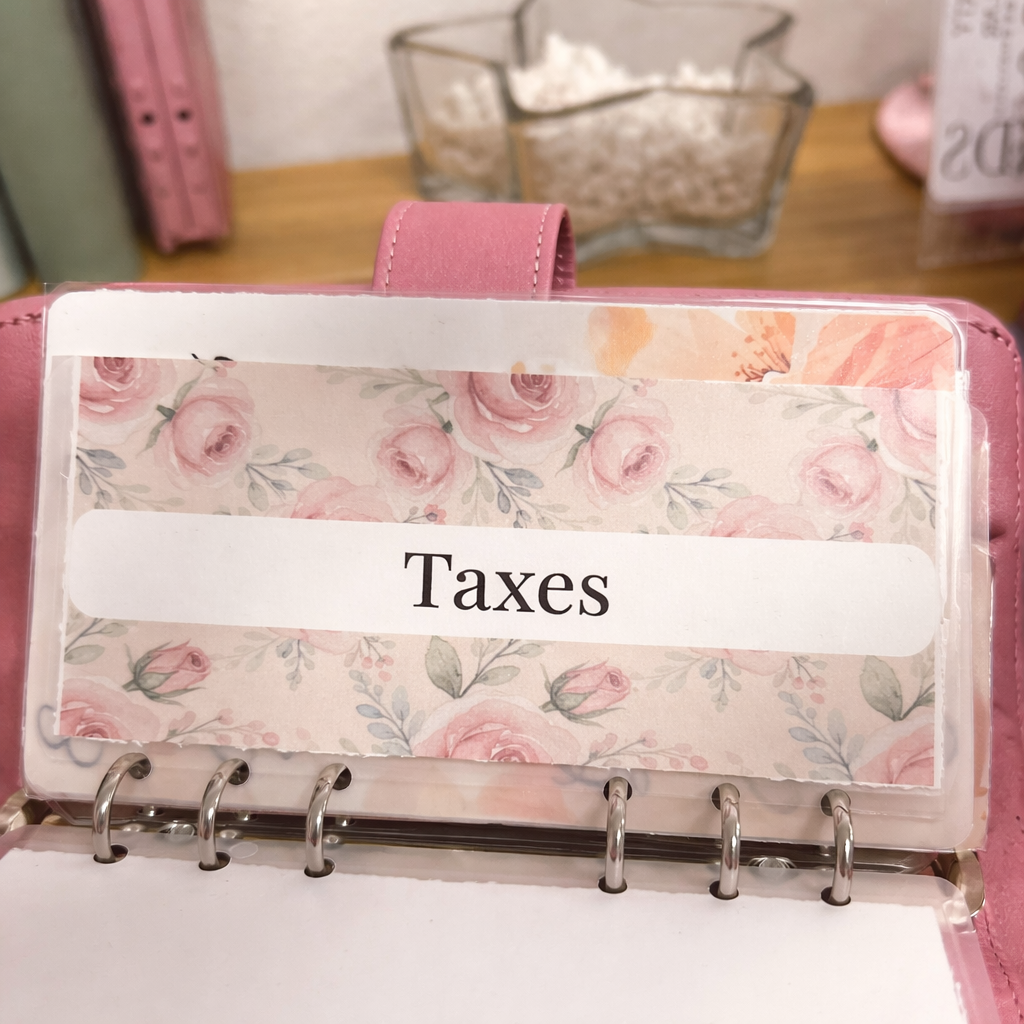 Floral planner with a 'Taxes' label on a desk