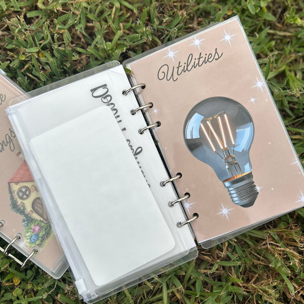 Open notebook with a light bulb illustration on a grassy background