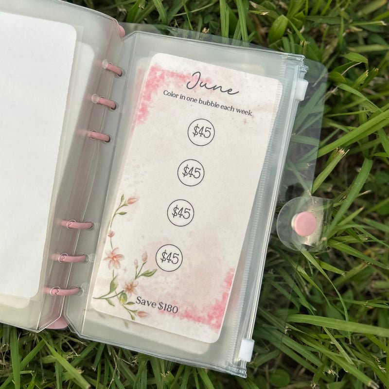 Planner with a June-themed card on grass