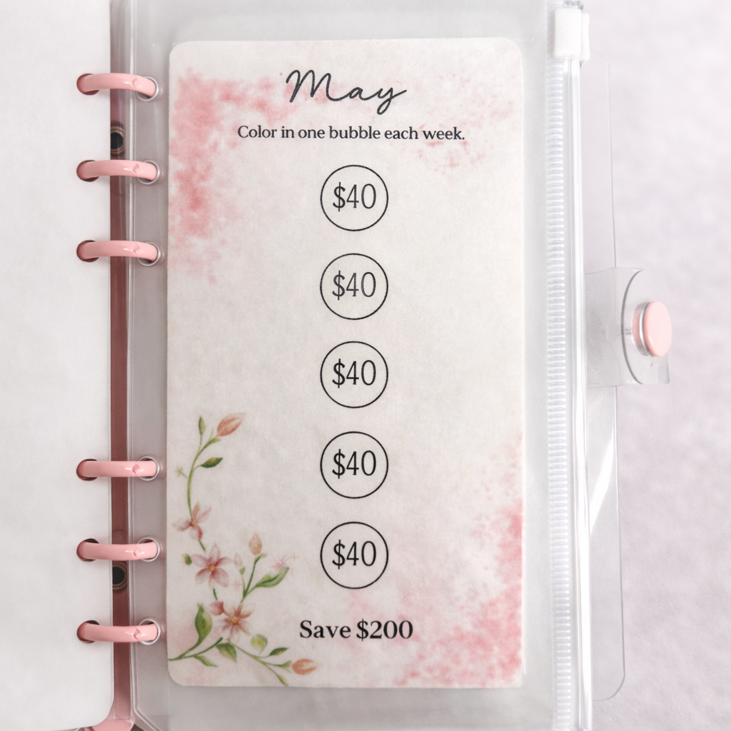 Planner with a May savings tracker card on a light gray background