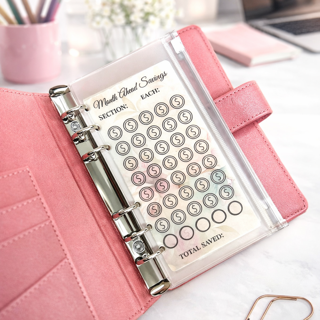 Pink planner with money-saving tracker on a desk