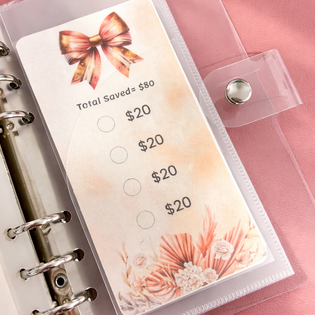 Money saving tracker with a decorative bow on a pink surface