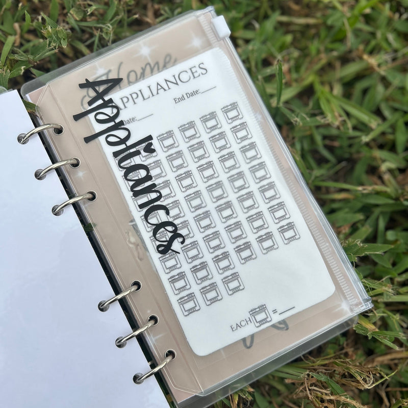 Planner with a page labeled 'Appliances' on grass