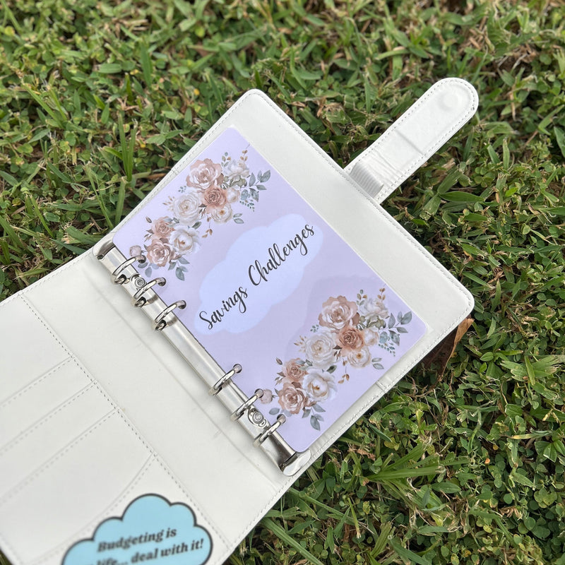 Open planner with floral design on a grassy background