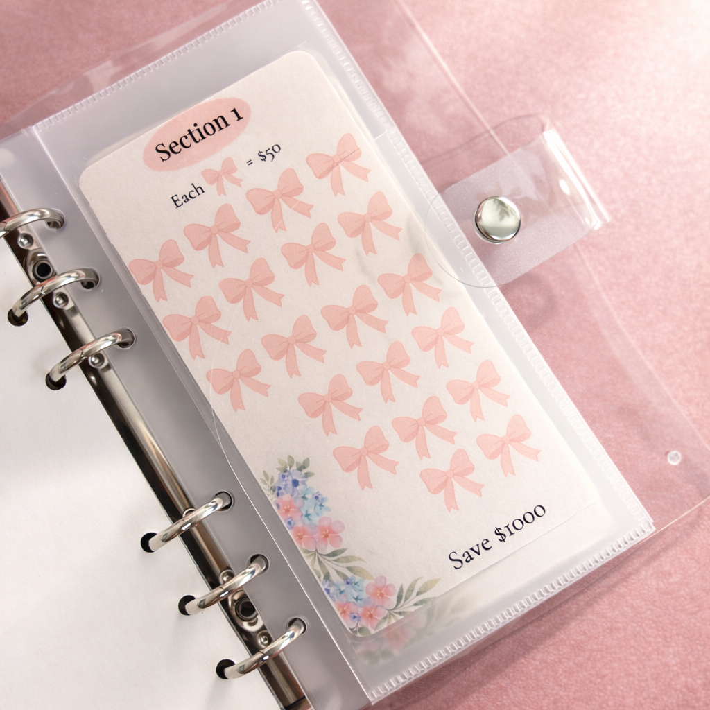 Planner with pink bow stickers on a pink background