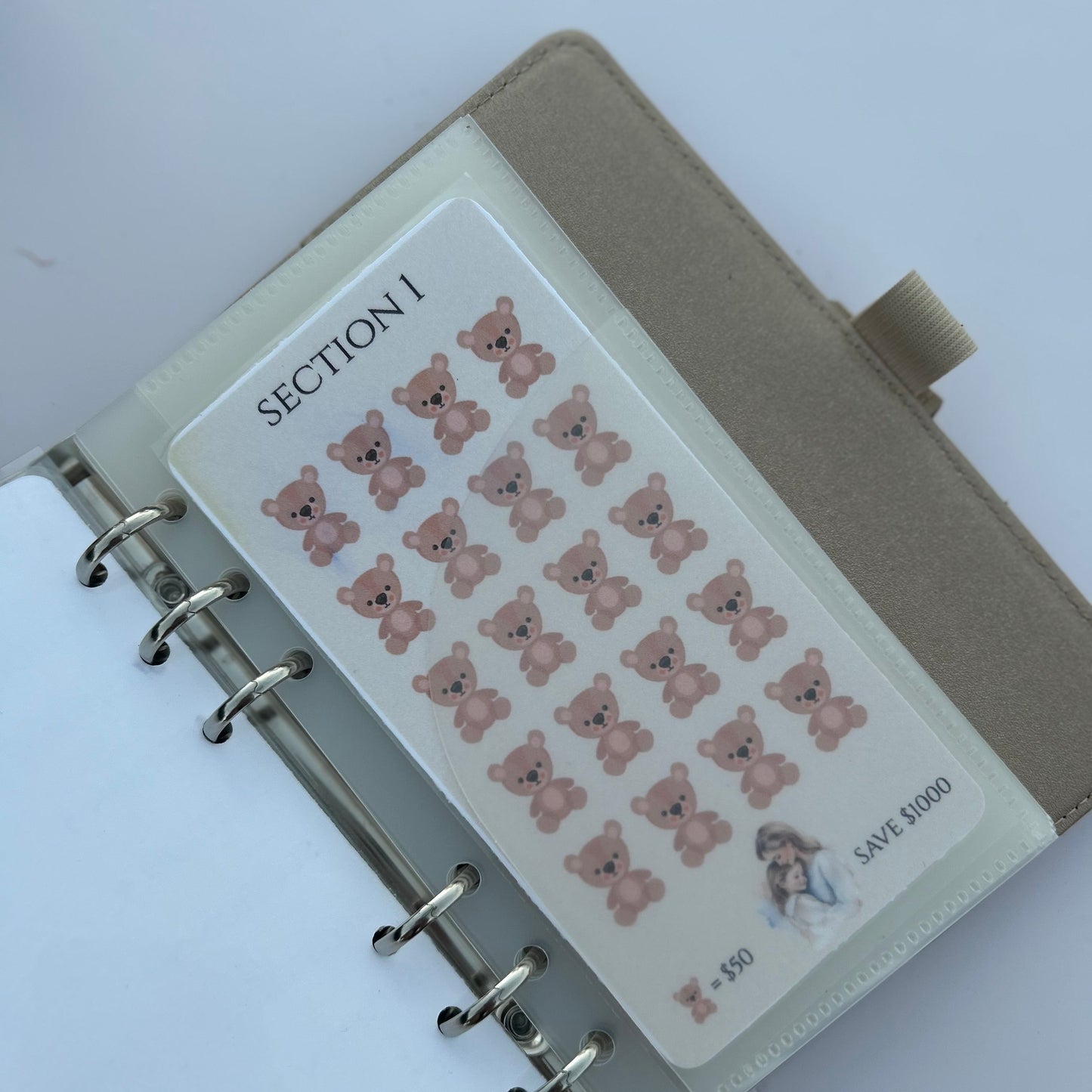 Notebook with a sheet of bear stickers on a white background
