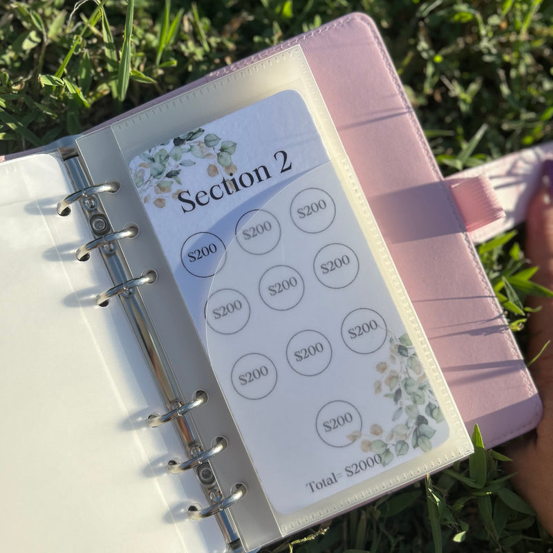 Planner with a money tracking sheet on grass