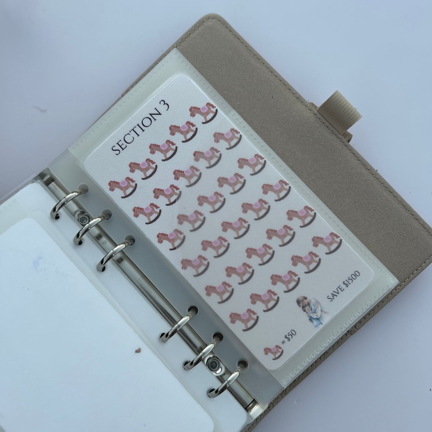 Planner with pink horse stickers on a white background