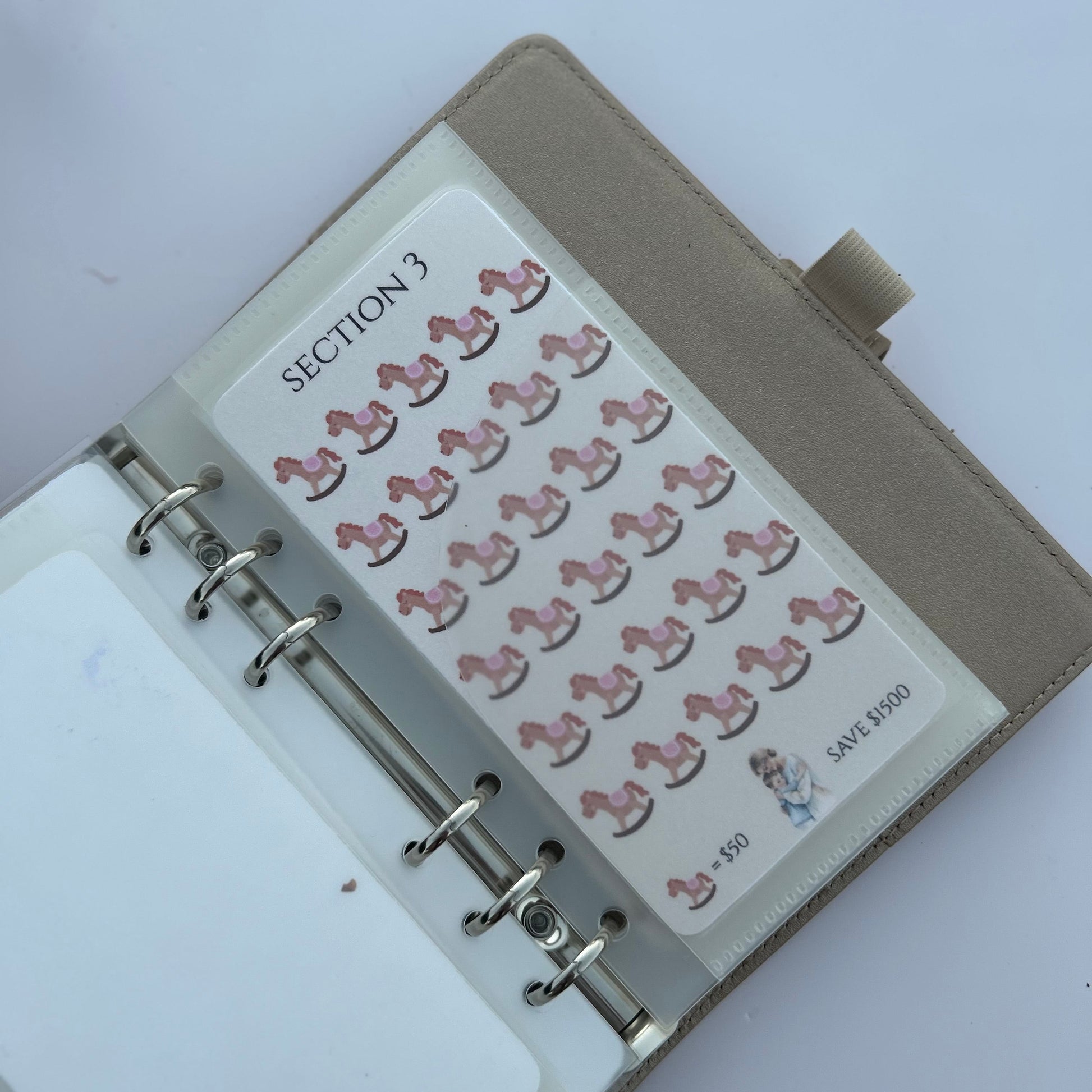 Planner with pink horse stickers on a white background